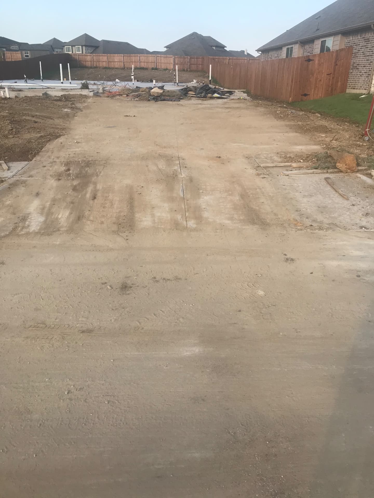 Driveway and approach concrete complete, site prepped for vertical construction.