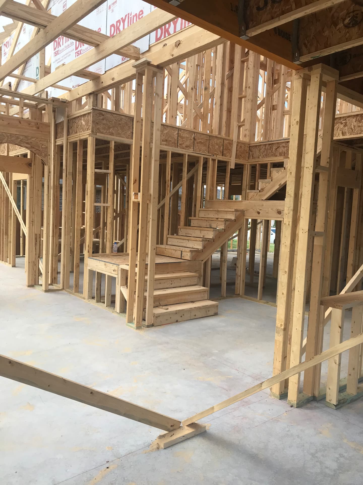 Interior walls, stair build, and open living volume taking shape.