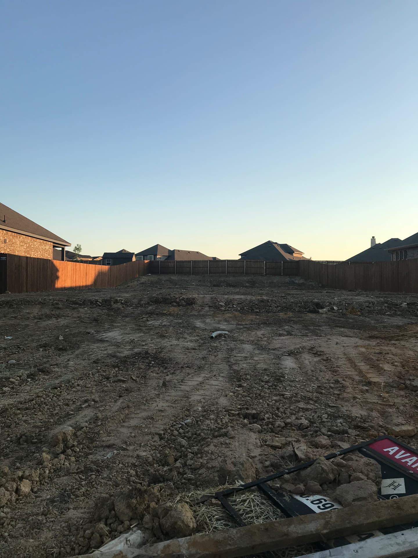 Cleared and graded homesite staked out and ready for foundation work.